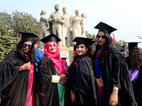 A group of graduates expressing their delight in front of the sculpture Raju at TSC area, on the 52th convocation of the students of Dhaka U...