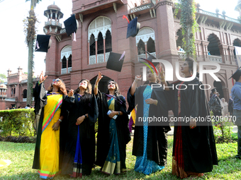 A group of graduates expressing their delight in front of the Curzon hall at university area, on the 52th convocation of the students of Dha...