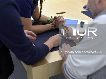 An Apple fan is helped by a store staff member during the in-store preview event for new Apple Watch in Melbourne, Australia on April 12, 20...