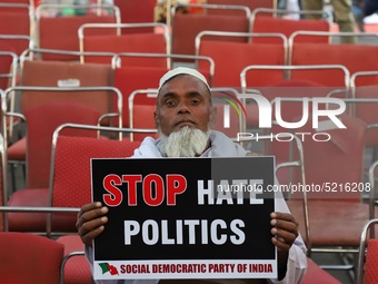 An elderly man holds a playcard during a protest against the citizenship amendment bill in New Delhi India on 10 December 2019.  (