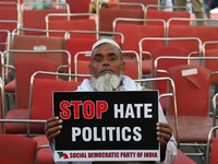 An elderly man holds a playcard during a protest against the citizenship amendment bill in New Delhi India on 10 December 2019.  (