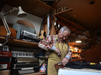 Former theatre actor and long time artist and luthier, Jozef Gmyrek (age 71), repairs a guitar in his workshop. 
His work is not a job but a...