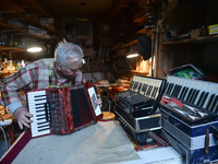 Former theatre actor and long time artist and luthier, Jozef Gmyrek (age 71), tunes an accordion in his workshop.
His work is not a job but...
