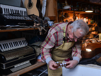 Former theatre actor and long time artist and luthier, Jozef Gmyrek (age 71), tunes a guitar in his workshop. 
His work is not a job but a p...