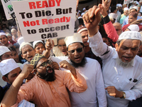 Muslim activists hold placards and shout slogans during a protest against the Citizenship Amendment Bill (CAB) in Mumbai, India on 13 Decemb...