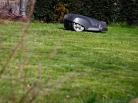 An automated lawn mowing machine or robot is seen mowing a lawn. Several weeks ago Robert Reich, the former Labor Secretary under Bill Clint...