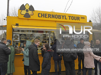Visitors stand next to a souvenir shop on the Dytyatky checkpoint in Chernobyl, Ukraine, on 25 December, 2019. The Chernobyl disaster on the...