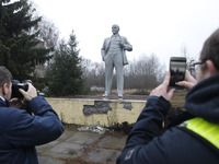Visitors take a photo of a monument of the Soviet leader Vladimir Lenin, in Chernobyl, Ukraine, on 25 December, 2019. The Chernobyl disaster...