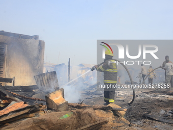 Firemen try to extinguish part of Kara market December 31, 2019. There have been no casualties reported, and the cause of the fire is as yet...