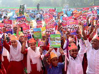 Student celebrate with new textbooks in hand at the Dhaka University sports ground the Dhaka University sports ground as the government kick...