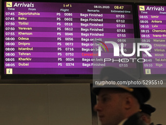 A screen displayed information on flights, including the one from Tehran marked as cancelled is seen at the Boryspil International Airport,...