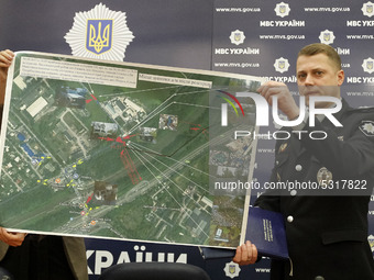 A police officer shows for journalists a map of the site where Amina Okuyeva was shot dead, during a press-briefing about the results of the...