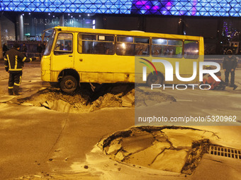 A bus is seen in a pit on the road, after a central heating pipe breakthrough in the central district of Kyiv, Ukraine, on 13 January, 2020....