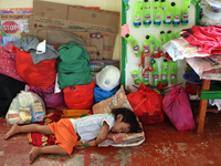 Hundreds of people affected by the eruption of the Taal volcano have been evacuated from a school in Bauan, in Batangas province on 16 Janua...