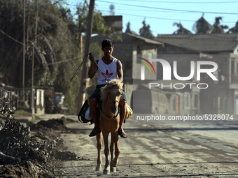 A man horse riding on a road covered with volcanic ash in Agoncillo, in the province of Batangas, Philippines, on 16 January 2020. Taal volc...