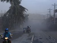 Several motorcycles ride on a road covered with volcanic ash in Agoncillo, in the province of Batangas, Philippines, on 16 January 2020. Taa...