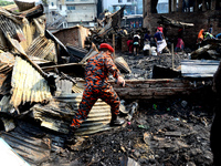Bangladeshi firefighters seen searching after a devastating fire that broke out at Chalantika slum last night in Dhaka, Bangladesh, on Janua...