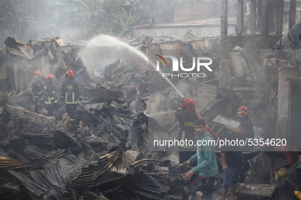 Bangladeshi firefighters extinguish a fire that broke out at Chalantika slum last night in Dhaka, Bangladesh, on January 24, 2020. At least...