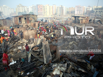 Bangladeshi Slum dwellers seen searching for their household belongings after a devastating fire that broke out at Chalantika slum last nigh...
