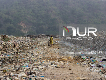 A Indian girl look for recyclable materials in a dumping site on the eve of World Earth Day in Guwahati in the Northeastern state of Assam o...