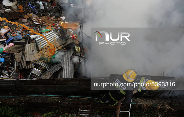 Firefighters along with Army and Police work to put out a fire at warehouse, located in Lalitpur , Kathmandu, on Sunday, February 02, 2020. 