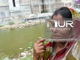 Dhaka 22 April 2015. A women visit the site of the Rana Plaza building ruins in search of a lost loved one. Thousands of mourners commemorat...