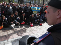 Ukrainian coalminers bang on the ground with their helmets as they attend a rally in front of the Ukrainian Parliament, in Kiev, Ukraine, 23...