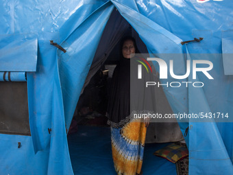 A survivor mother is active in her emergency tent at the Agung Mosque shelter in Palu, Central Sulawesi, Indonesia on February 13, 2020. Hun...
