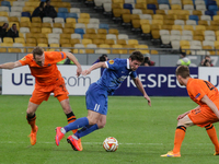 Yevhen Seleznyov (C) of Dnipro vies for the ball with Brandon Mechele (R) and Laurens De Bock (L) of Brugge during the UEFA Europa League qu...