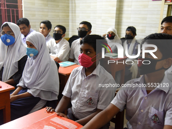 Bangladeshi Students wearing facemasks in their school as a preventive measure against the spread of the COVID-19 coronavirus outbreak, in D...