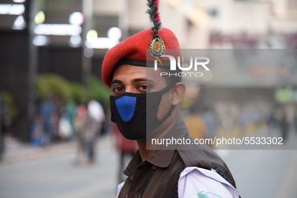 A Bangladeshi security person wearing facemasks during duty on the street as a preventive measure against the spread of the COVID-19 coronav...