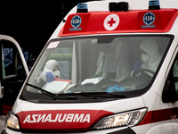 An ambulance car with a driver wearing a protective mask arrive at the Padua hospital with a coronavirus patient on March 10, 2020 in Padova...