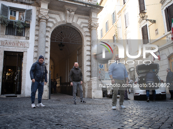 Some people play with a soccer ball in the streets near the Senate Palace during the Coronavirus emergency, on March 10, 2020, in Rome, Ital...