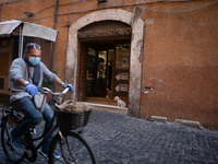 A man on the bike while wearing protective gear on the streets of the historic center of Rome during the Coronavirus emergency, on March 10,...