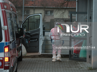 A health worker wears a protective body against coronavirus in Wroclaw, Poland, on March 10, 2020.  More and more coronavirus infected peopl...
