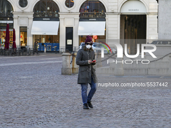 A man wears a protective respiratory mask in the center of Turin, on March 10, 2020, after Italy imposed unprecedented national restrictions...