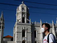 A men wearing a mask walks by the Jeronimos Monastery in Lisbon, Portugal, on March 10, 2020. The epidemiological situation in Portugal cont...