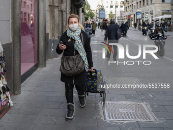 A woman wears a protective respiratory mask in the center of Naples, Italy March 09, 2020 (