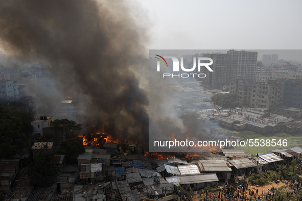 A column of smoke rises into the sky above the town in the event of a fire in Mirpur, Dhaka on March 11, 2020. The fire caused strong smoke...