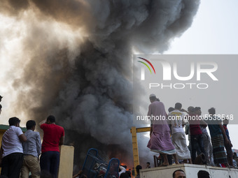 A column of smoke rises into the sky above the town in the event of a fire in Mirpur, Dhaka on March 11, 2020. The fire caused strong smoke...