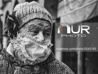 (EDITOR'S NOTE: Image was converted to black and white)  An elderly lady, who went to the market in Piazza delle Erbe for shopping, wears a...
