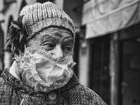 (EDITOR'S NOTE: Image was converted to black and white)  An elderly lady, who went to the market in Piazza delle Erbe for shopping, wears a...