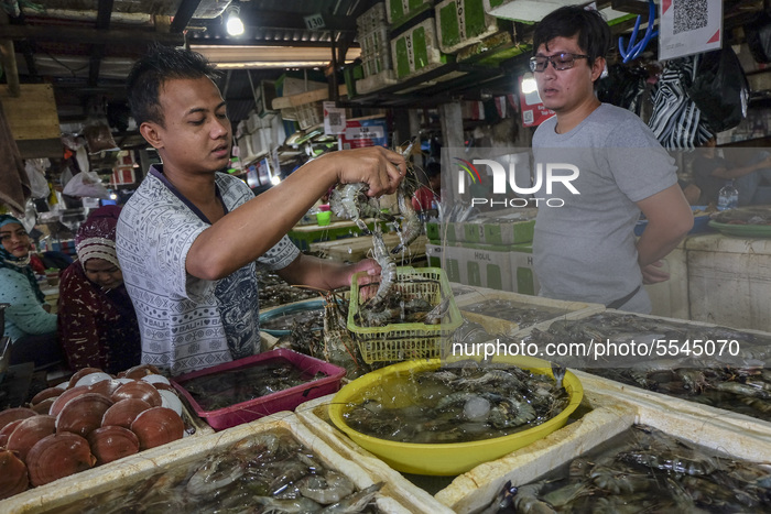  The sight of seafood sellers looks empty due to the effects of the coronavirus outbreak (COVID-19) at the Kedonganan Fish market, Jimbaran...