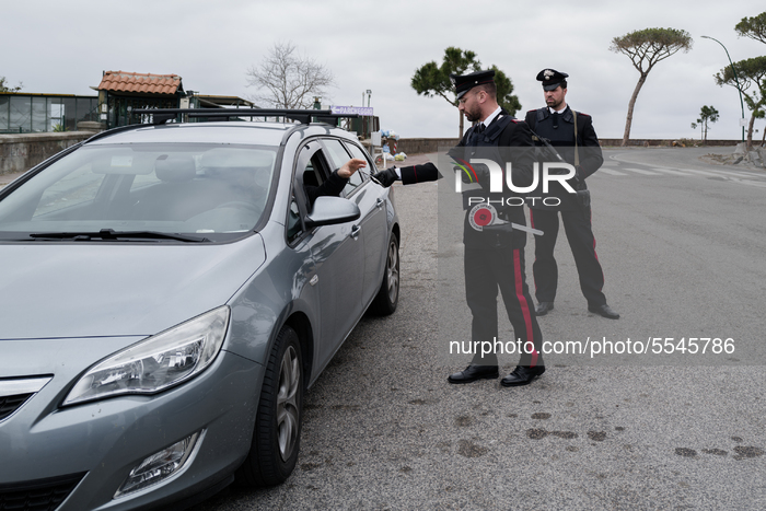 Carabinieri officers control road traffic in Naples on March 13, 2020, as Italy shut all stores except for pharmacies and food shops in a de...