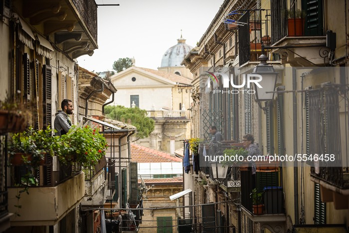 People stay on the balconies following the spread of the Coronavirus in Lanciano, Italy, on March 14, 2020.  (Photo by Federica Roselli/NurP...