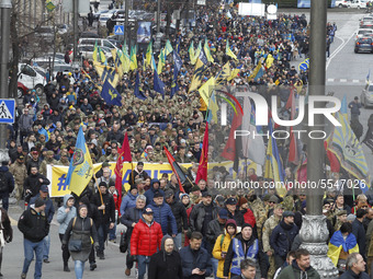 People participate at a rally called 'March of Patriots' at the Volunteer Day in honor of volonteer fighters who joined Ukrainian Army at a...