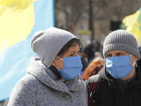 People wearing protective masks participate at a rally called 'March of Patriots' at the Volunteer Day in honor of volonteer fighters who jo...