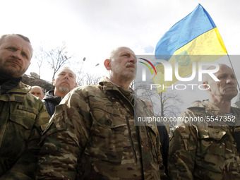 People participate at a rally dedicated to the Volunteer Day in honor of volonteer fighters who joined Ukrainian Army at a war conflict at e...