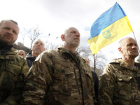 People participate at a rally dedicated to the Volunteer Day in honor of volonteer fighters who joined Ukrainian Army at a war conflict at e...