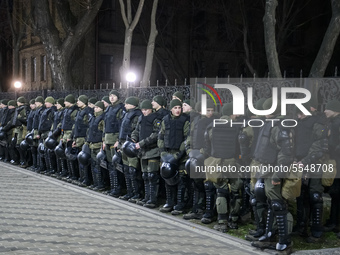 Policemen stand guard ahead of a rally outside the Russian embassy to mark the Volunteer Day honouring fighters, who joined the Ukrainian ar...
